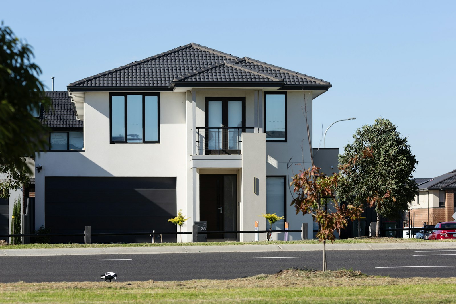 Two-story house with a dark garage door facing the street