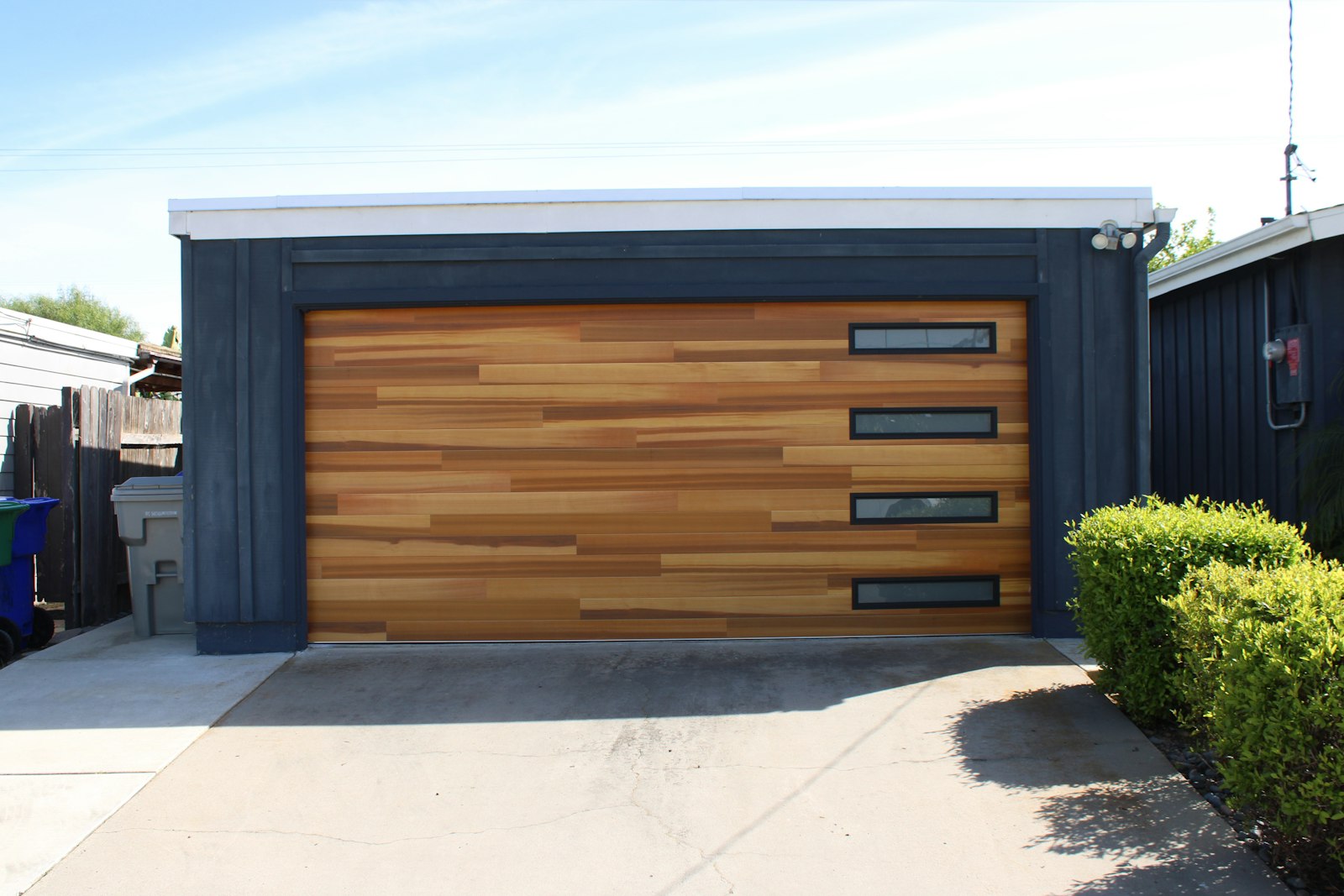 Wood-look garage door with a row of narrow windows
