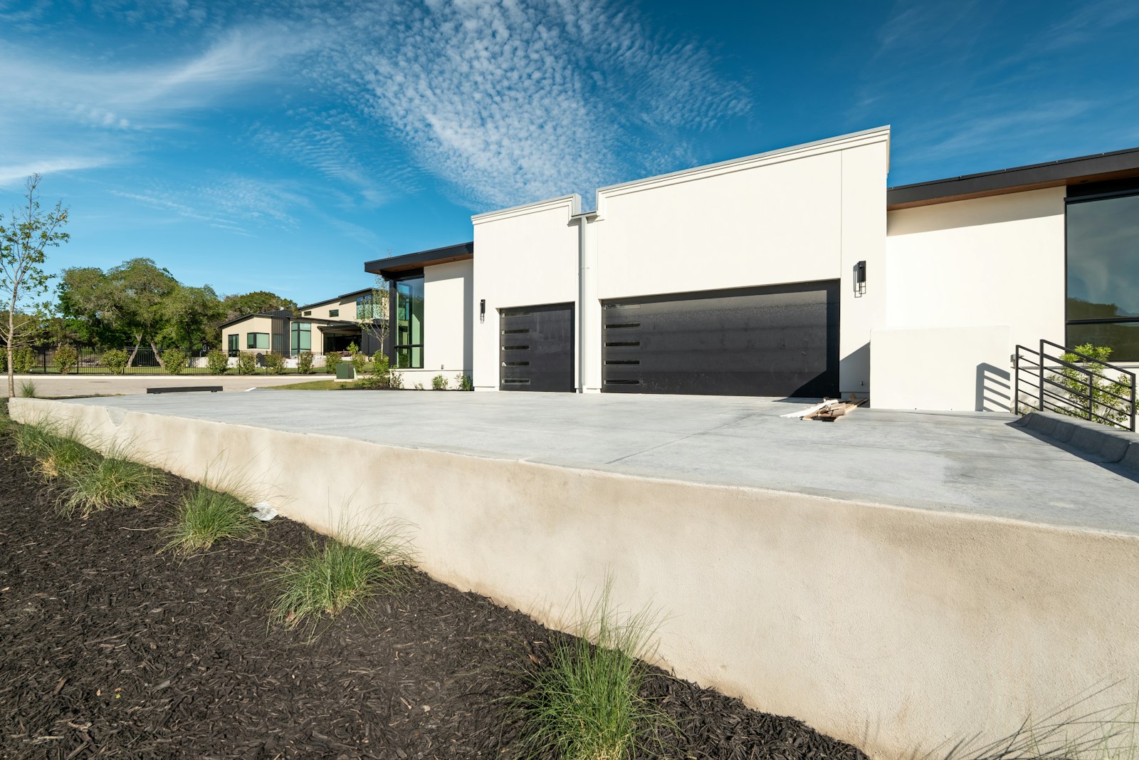White modern home with a black sectional garage door
