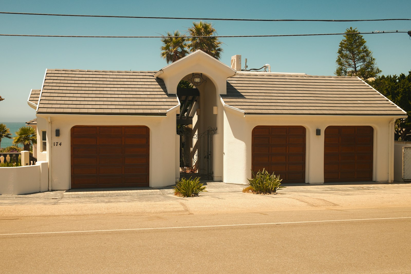 Single-story home with three wooden garage doors