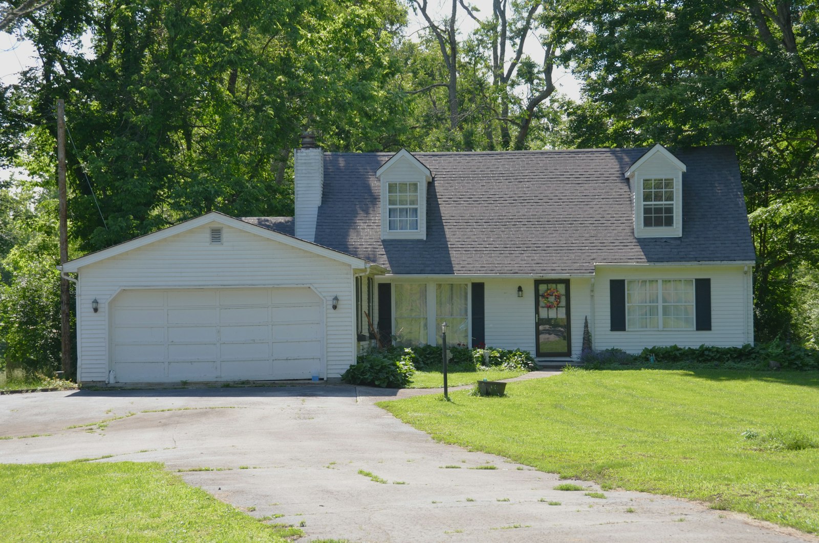 Suburban house with a white two-car garage door and driveway